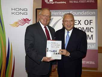 Chief Executive Tung Chee Hwa received the report from Heritage Foundation President Ed Feulner.