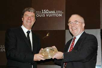 Mr Mike Rowse (right) presents a souvenir plaque to Mr Yves Carcelle to congratulate him on Louis Vuitton's 150th anniversary. 