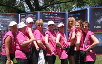 A team of female dragon boat paddlers proudly show  off the stylish Brand HK icon painted on their arms at the annual Dragon Boat Race Festival.