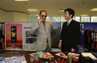 Mr Galpin (left) tries on the sunglasses produced in Japan's Fukui Prefecture.  The company announced the opening of its first HQs in Hong Kong.