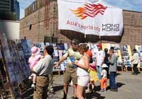 Calgarians visiting the photo display depicting life in Hong Kong in the past and present at the Calgary Chinatown Festival. 