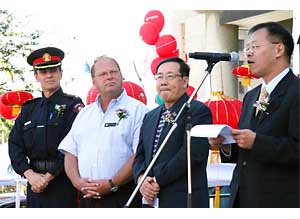 Mr Bassanio So speaks at the opening ceremony of the Calgary Chinatown Street Festival with other officiating guests including (from right) Chinese Consul General in Calgary, Mr Song Xizhu; Solicitor General of Alberta, the Hon Harvey Cenaiko; and Calgary's Deputy Police Chief, Mr Peter Davison.