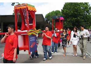 The "Brand Hong Kong" sedan chairs becomes the focus of attention at the opening procession of the 18th Toronto International Dragon Boat Race Festival.