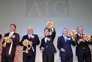 Picture shows Mr Tsang and other officiating guests performing a ribbon-cutting ceremony at the AIG Asia Regional Headquarters Opening Ceremony. 