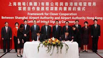 Picture shows Mr Tung (fifth left) and Mr Han(fifth right) witnessing the signing of Letter of Intent to map out the framework for co-operation between the Shanghai Airport Authority and the Airport Authority of Hong Kong.